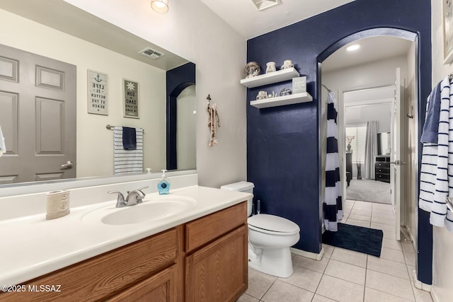 bathroom with visible vents, toilet, vanity, and tile patterned flooring