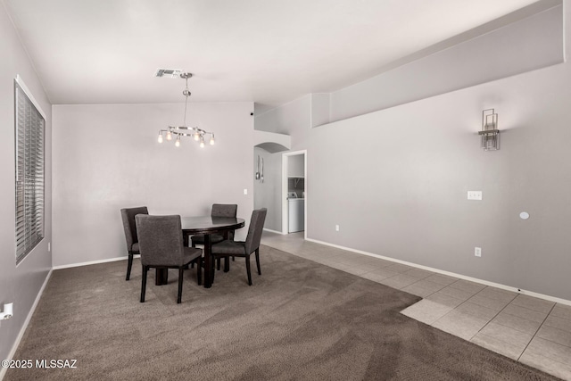 tiled dining area with visible vents, a chandelier, vaulted ceiling, carpet flooring, and arched walkways