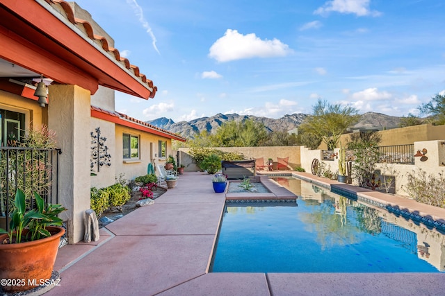 view of pool with a fenced in pool, a fenced backyard, a patio area, and a mountain view