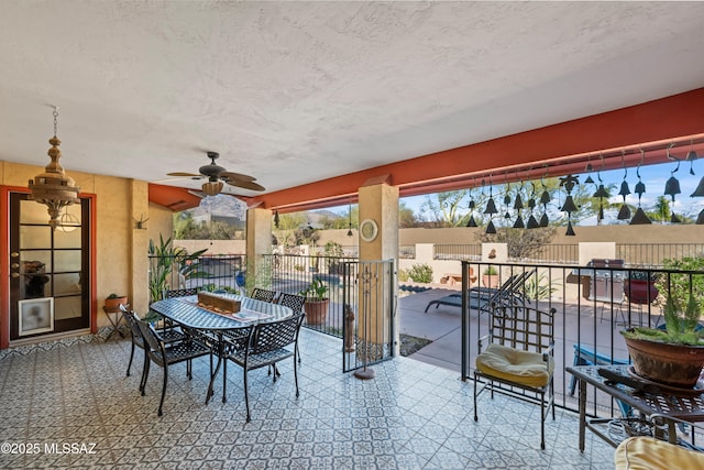 view of patio / terrace with fence, a ceiling fan, and outdoor dining space