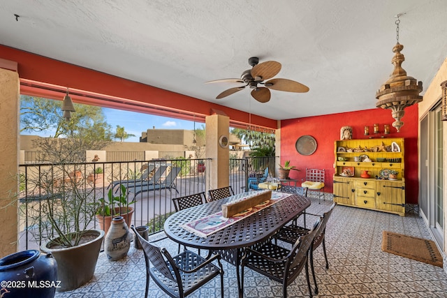 exterior space with ceiling fan and a textured ceiling