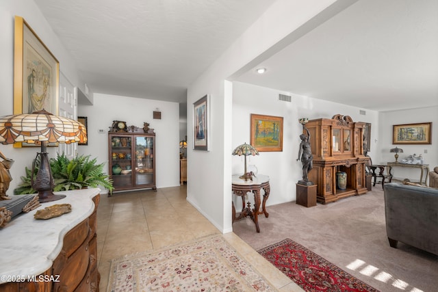 interior space with visible vents and light carpet