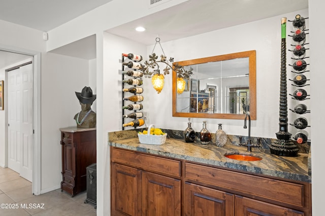 interior space featuring a sink, light tile patterned floors, recessed lighting, and wet bar