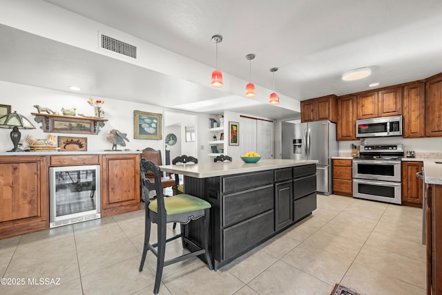 kitchen featuring brown cabinets, light countertops, stainless steel appliances, wine cooler, and visible vents
