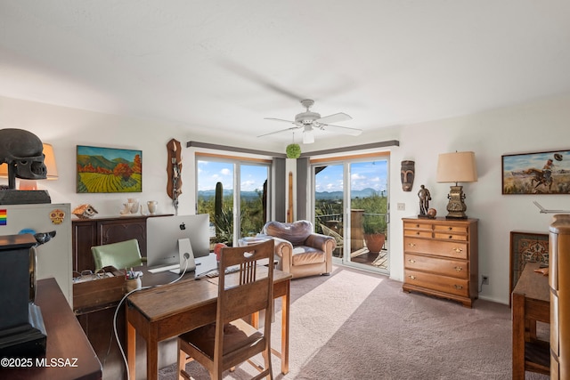carpeted dining room with ceiling fan