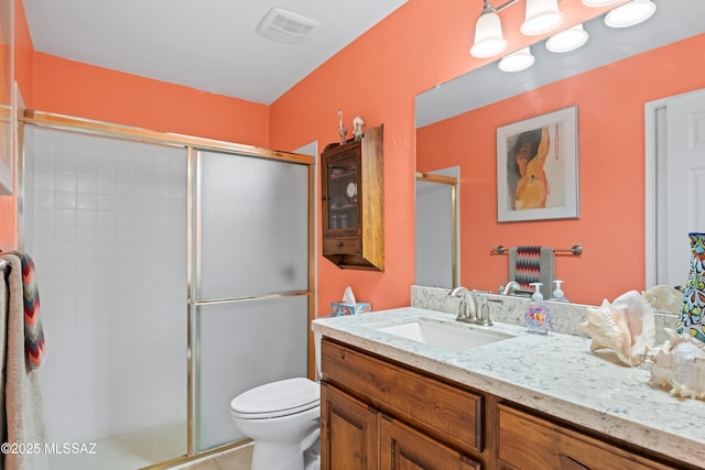 bathroom with vanity, toilet, tile patterned floors, visible vents, and a stall shower