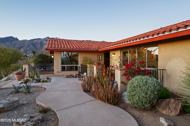 view of patio with a mountain view and fence