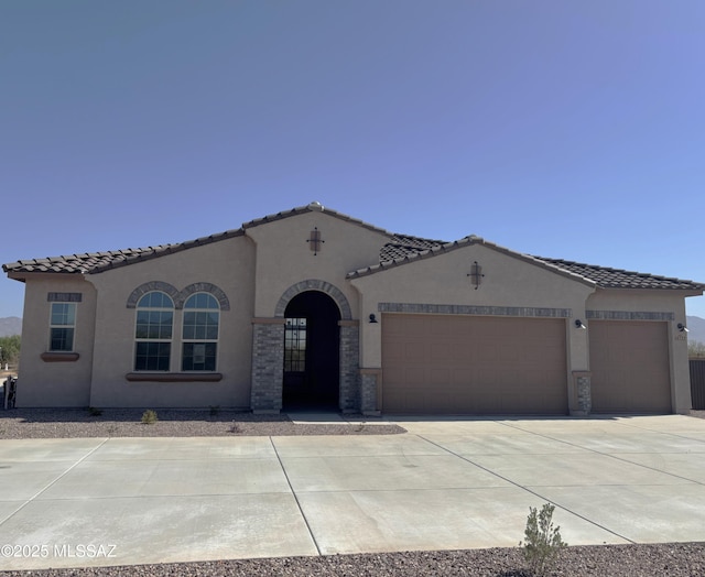 14722 E Sands Ranch Rd, Vail, AZ 85641 - mediterranean / spanish house featuring stucco siding, an attached garage, driveway, and a tile roof