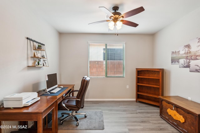 office area with ceiling fan, baseboards, and wood finished floors