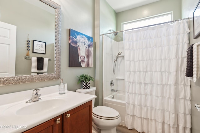 bathroom with shower / bath combo with shower curtain, toilet, and vanity