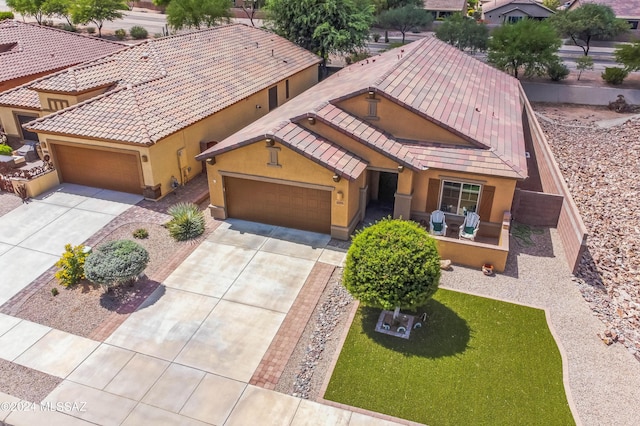 view of front of property with stucco siding, driveway, and an attached garage