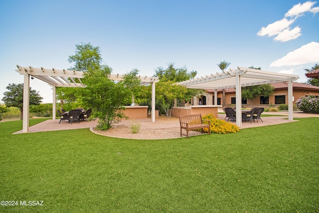 view of yard with a patio, a pergola, and an outdoor kitchen