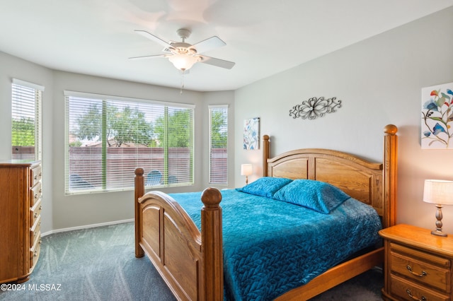 carpeted bedroom with baseboards, multiple windows, and a ceiling fan