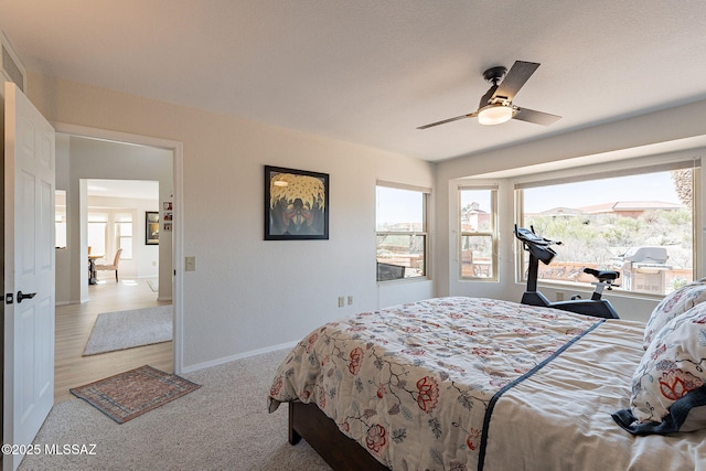 bedroom with multiple windows, baseboards, and ceiling fan