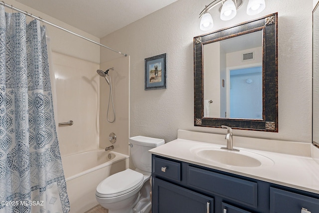 bathroom featuring visible vents, toilet, shower / tub combo, a textured wall, and vanity