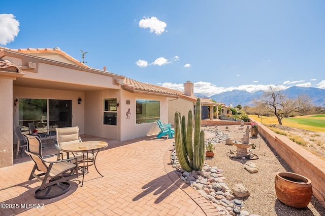 view of patio / terrace featuring a mountain view and fence