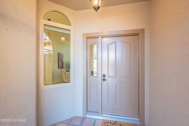 doorway to property with stucco siding