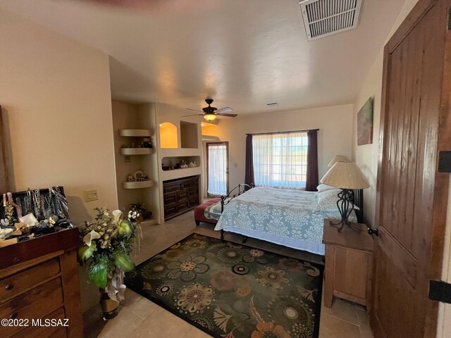 kitchen featuring visible vents, open floor plan, appliances with stainless steel finishes, light tile patterned flooring, and a fireplace