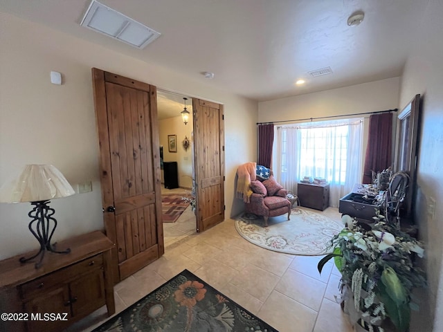 sitting room featuring visible vents and light tile patterned flooring