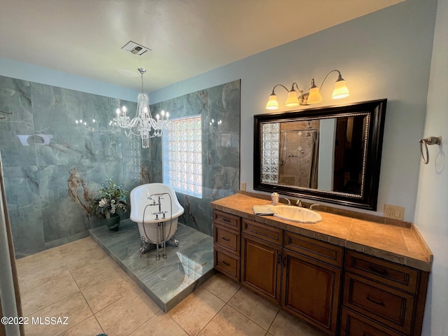 full bath featuring visible vents, a notable chandelier, tiled shower, a soaking tub, and vanity