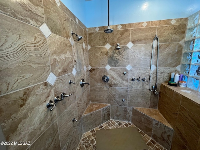 full bath featuring a tile shower