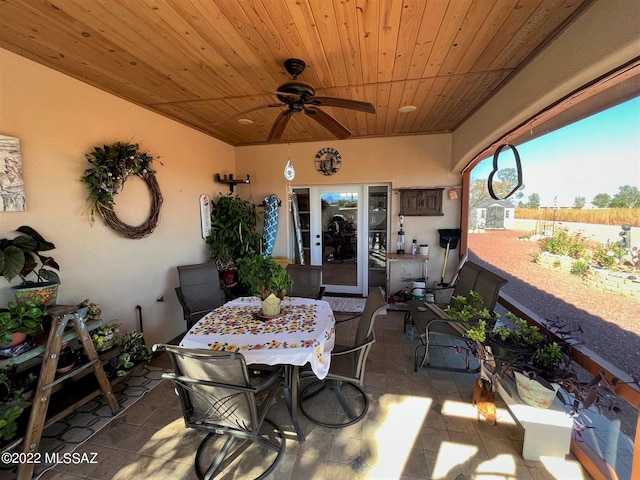 view of patio with outdoor dining area and a ceiling fan