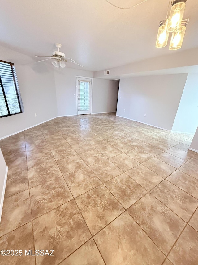 spare room with light tile patterned floors, baseboards, visible vents, and ceiling fan