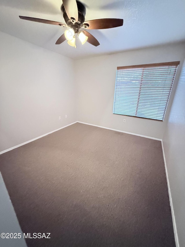 spare room featuring baseboards and carpet flooring