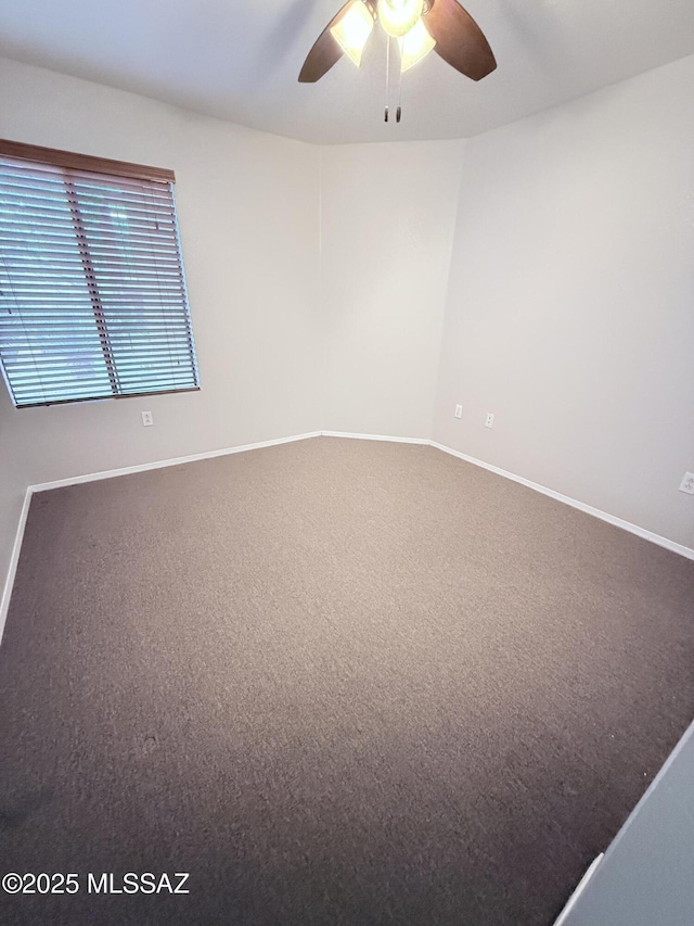 spare room with ceiling fan, baseboards, and carpet floors