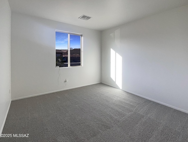 unfurnished room featuring visible vents, baseboards, and carpet floors