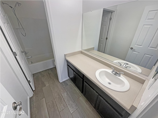 full bathroom with vanity, wood finished floors, and shower / bathtub combination