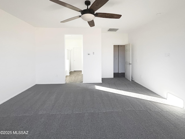 unfurnished bedroom featuring visible vents, a ceiling fan, and carpet floors