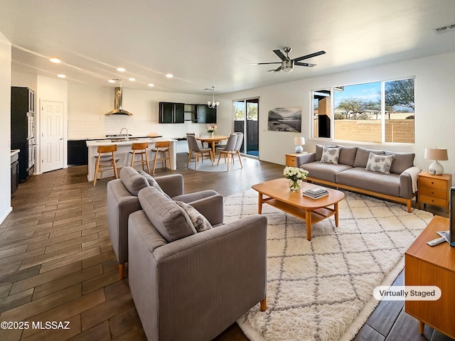 living room with dark wood finished floors, visible vents, recessed lighting, and ceiling fan