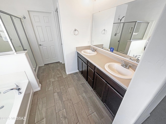 bathroom featuring a sink, a stall shower, and wood tiled floor