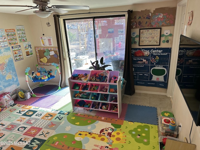 rec room with tile patterned floors and a ceiling fan