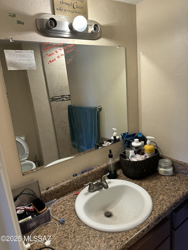 bathroom with vanity and a textured wall