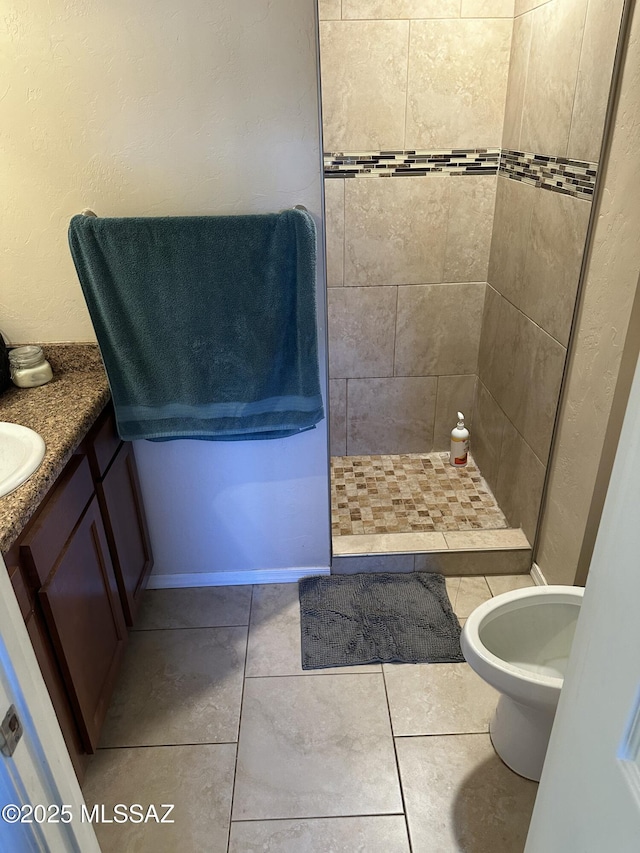 bathroom with tile patterned floors, a stall shower, and vanity