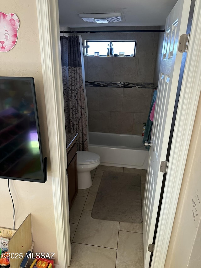 bathroom with vanity, visible vents, tile patterned flooring, shower / bath combo with shower curtain, and toilet