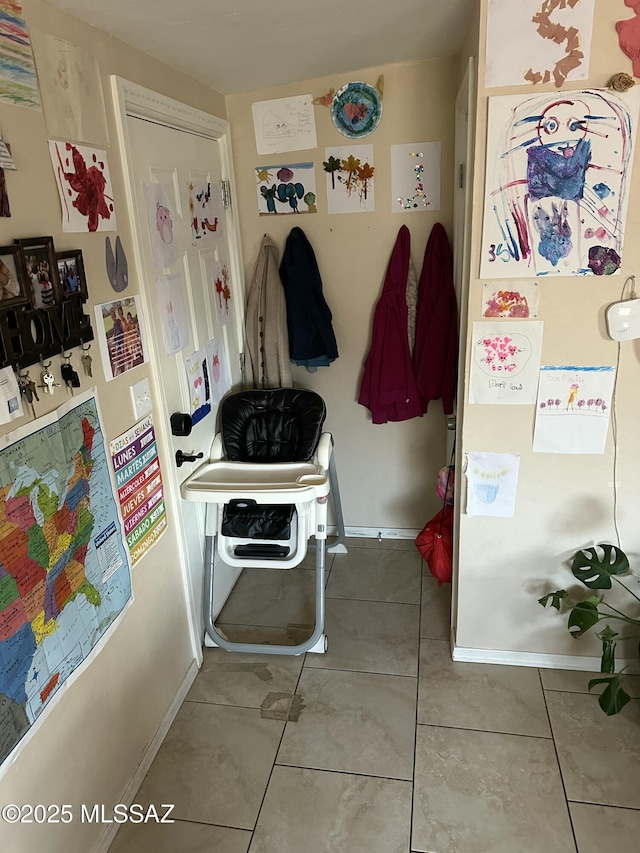 mudroom with baseboards and tile patterned flooring