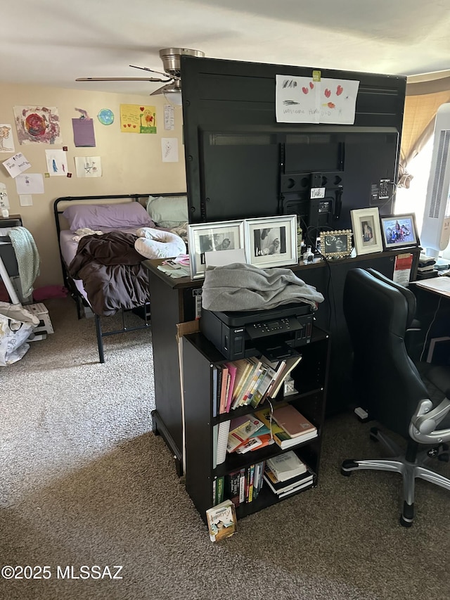 carpeted home office featuring ceiling fan