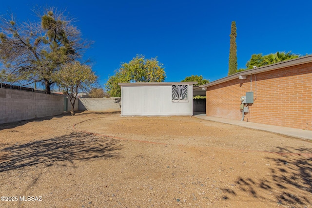 view of yard featuring an outbuilding and fence