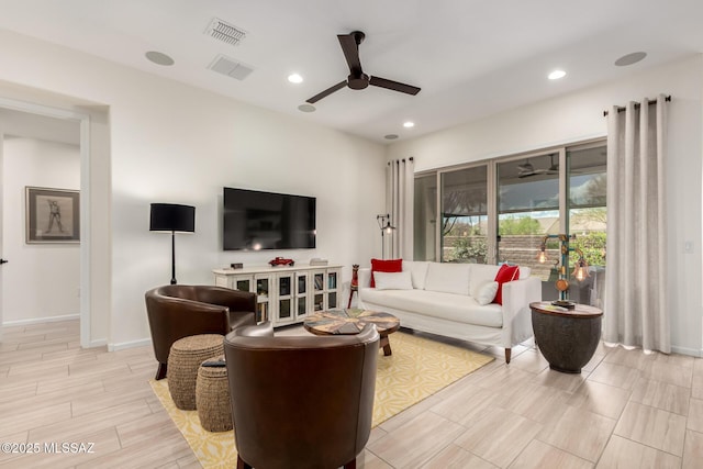 living room featuring recessed lighting, baseboards, ceiling fan, and visible vents