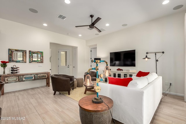 living room with baseboards, visible vents, recessed lighting, and a ceiling fan