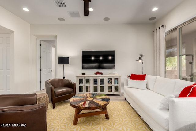 living area featuring visible vents and recessed lighting