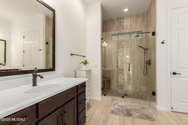 bathroom featuring vanity and a shower stall