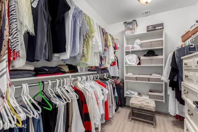 walk in closet featuring visible vents and wood finished floors