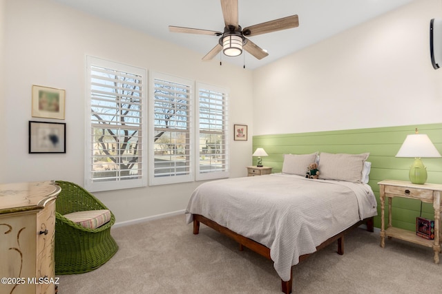 carpeted bedroom with baseboards and ceiling fan
