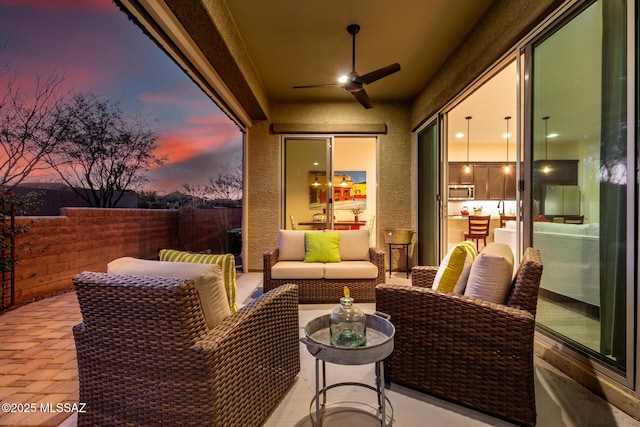 view of patio featuring an outdoor hangout area and a ceiling fan