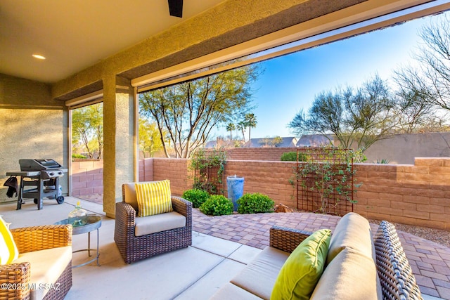 view of patio / terrace with a fenced backyard, grilling area, and an outdoor hangout area