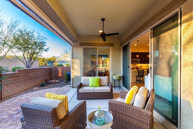view of patio / terrace with a fenced backyard, ceiling fan, and outdoor lounge area